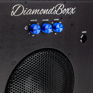 zoomed in view of diamondboxx logo and power button on the front of black SUB8.2 with blue knobs